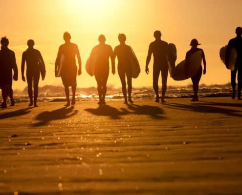 Taking friends surfing on a group travel adventure.